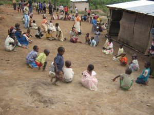 volunteers playing games with children in Uganda