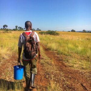 Ugandan farmer walking to his fields