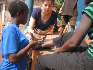 Volunteer teaching wound care in Uganda