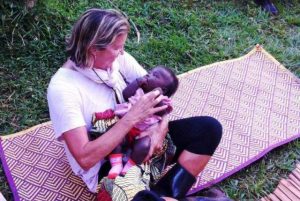 A volunteer holding a Ugandan baby