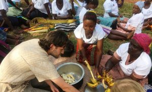 volunteers cooking food in uganda