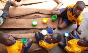Ugandan school kids enjoying porridge