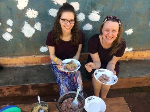 volunteers in Uganda eating traditional food