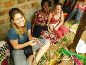 volunteers weaving mats in Uganda